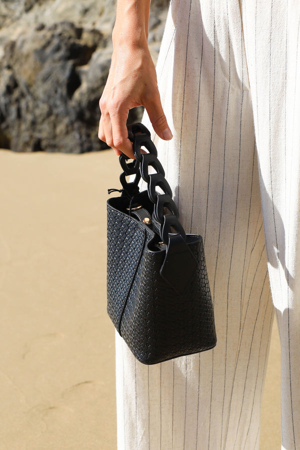 black crossbody and handle bucket bag