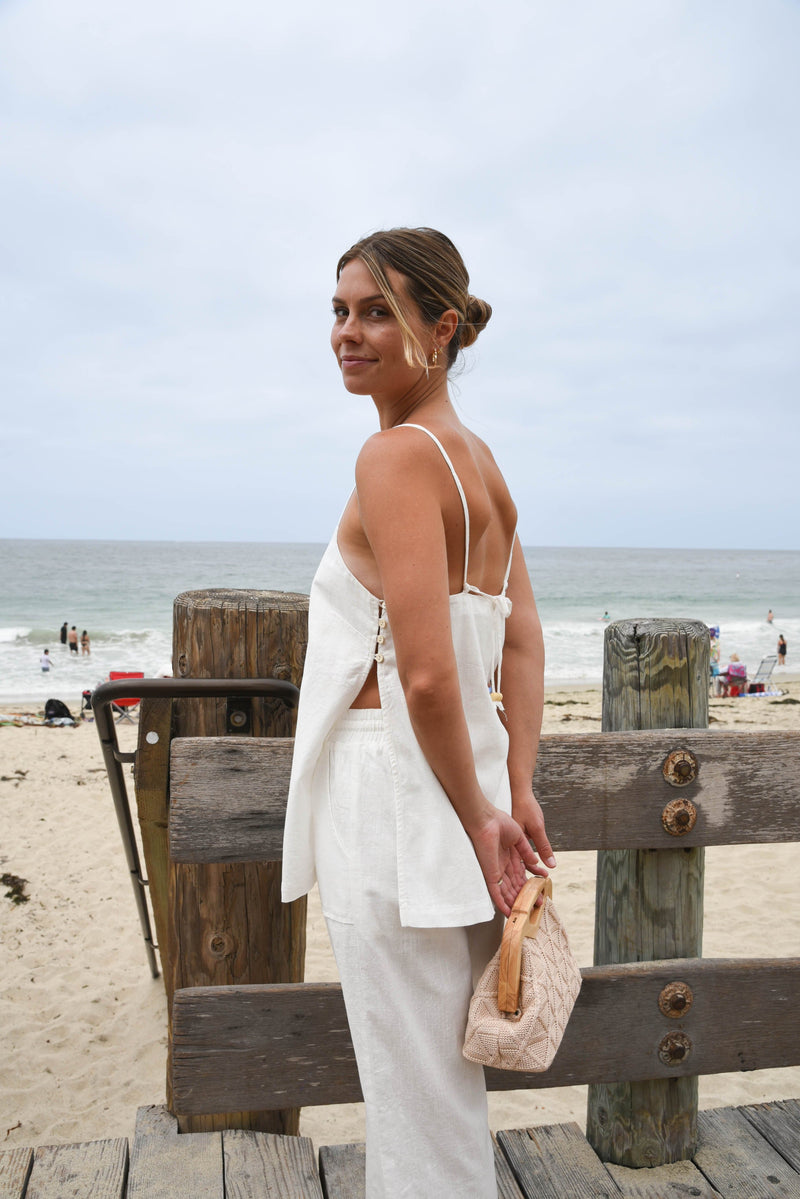 Woman in a white linen pant and tank matching set outfit 