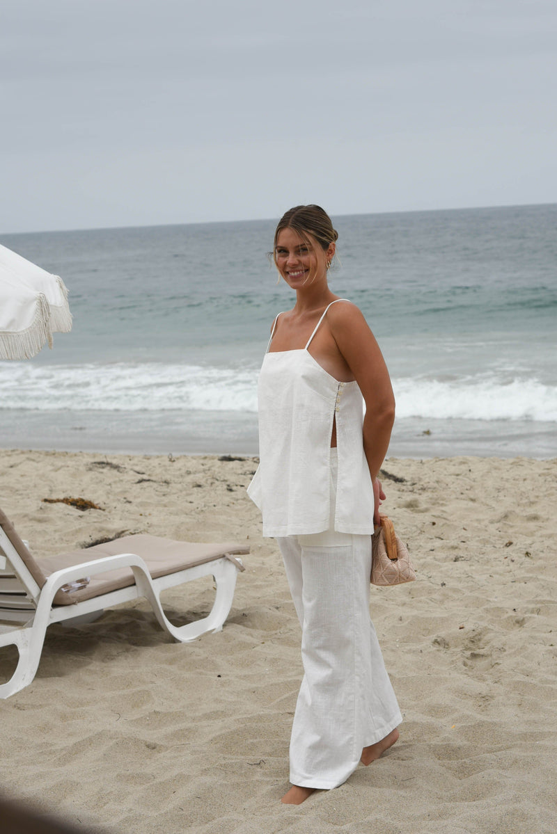 Woman in a white linen pant and tank matching set outfit 