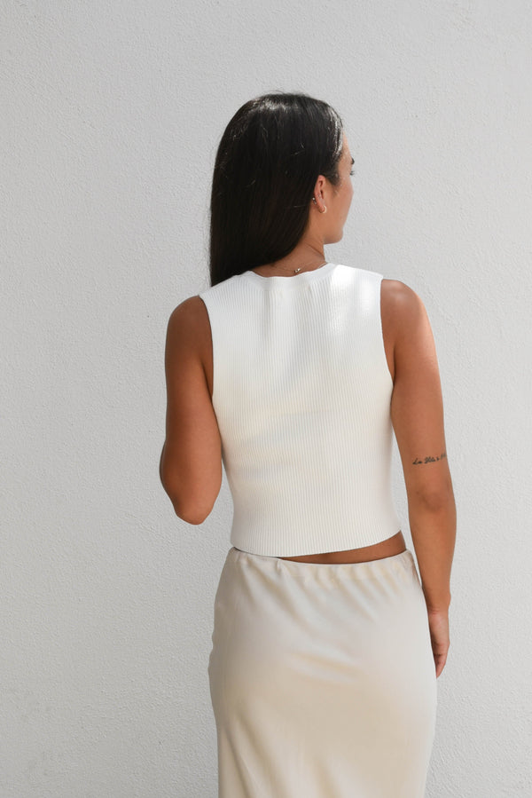 a white sleeveless top with cut-out design 